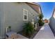 Clean backyard with a paved pathway, landscaping, and exterior mechanicals at 15320 W Baden St, Goodyear, AZ 85338