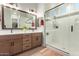 Spa-like bathroom with a walk-in shower, double vanity, and modern fixtures at 15320 W Baden St, Goodyear, AZ 85338