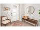 Entryway with a bench, mirror, and antique chair at 15320 W Baden St, Goodyear, AZ 85338