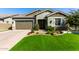 Single-story home with a two-car garage and landscaped front yard at 15320 W Baden St, Goodyear, AZ 85338