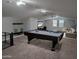 Spacious game room featuring a pool table, large tv, and comfortable seating area at 15320 W Baden St, Goodyear, AZ 85338