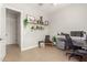 Bright home office with a desk, chair, and built-in shelving at 15320 W Baden St, Goodyear, AZ 85338