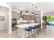 Modern kitchen with a large island, stainless steel appliances, and white quartz countertops at 15320 W Baden St, Goodyear, AZ 85338