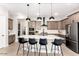 Charming kitchen featuring a large island with bar seating and stylish pendant lighting at 15320 W Baden St, Goodyear, AZ 85338
