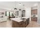 Open concept kitchen with large island and stainless steel appliances at 15320 W Baden St, Goodyear, AZ 85338
