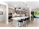 Beautiful modern kitchen features large island, stainless steel appliances, and custom cabinets at 15320 W Baden St, Goodyear, AZ 85338