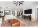 Open living room featuring a white couch, large TV, and kitchen views at 15320 W Baden St, Goodyear, AZ 85338