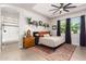 Bright main bedroom with a king-size bed, ceiling fan, and en-suite bathroom at 15320 W Baden St, Goodyear, AZ 85338