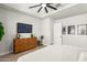 Main bedroom with king bed, dresser, and large TV at 15320 W Baden St, Goodyear, AZ 85338
