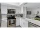 Modern white kitchen with stainless steel appliances at 1601 W Sunnyside Dr # 157, Phoenix, AZ 85029