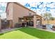 Landscaped backyard with a covered patio, pool, and artificial turf at 16958 W Marconi Ave, Surprise, AZ 85388