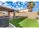 Artificial turf backyard with covered patio and pool at 16958 W Marconi Ave, Surprise, AZ 85388