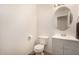 Simple and clean bathroom with a gray vanity and oval mirror at 16958 W Marconi Ave, Surprise, AZ 85388