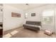 Bright bedroom with a gray sofa and large window at 16958 W Marconi Ave, Surprise, AZ 85388