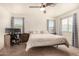 Spacious bedroom with large bed, work space, and ample natural light at 16958 W Marconi Ave, Surprise, AZ 85388