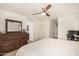 Comfortable bedroom with a large bed, dresser, and home office setup at 16958 W Marconi Ave, Surprise, AZ 85388