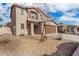 Two-story house with a brown garage door and desert landscaping at 16958 W Marconi Ave, Surprise, AZ 85388