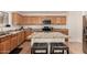 Kitchen boasts granite countertops and wood cabinets at 16958 W Marconi Ave, Surprise, AZ 85388