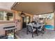 Covered patio with outdoor dining and pool access at 16958 W Marconi Ave, Surprise, AZ 85388