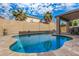 Relaxing kidney shaped pool with patio and seating at 16958 W Marconi Ave, Surprise, AZ 85388