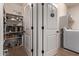 Well-organized laundry room with washer, dryer, and ample shelving at 18350 W Via Del Sol --, Surprise, AZ 85387