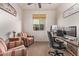 Home office with wood desk, comfortable seating, and ceiling fan at 18350 W Via Del Sol --, Surprise, AZ 85387