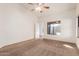 Bright bedroom with carpeted floor, ceiling fan and large window at 20212 N 33Rd St, Phoenix, AZ 85050