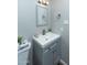 Bathroom with gray vanity, white countertop, and mirror at 2025 W Wood Dr, Phoenix, AZ 85029