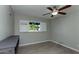 Bright bedroom with tile floors, ceiling fan, and window at 2025 W Wood Dr, Phoenix, AZ 85029