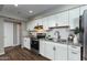 Updated kitchen with white shaker cabinets, granite counters, and stylish backsplash at 2025 W Wood Dr, Phoenix, AZ 85029