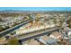 Aerial view of apartment complex near canal, with ample parking and surrounding cityscape at 2220 W Dora St # 215, Mesa, AZ 85201