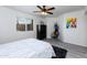 Bright bedroom with a comfortable bed, window, and ceiling fan at 2220 W Dora St # 215, Mesa, AZ 85201