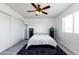Cozy bedroom featuring a bed, ceiling fan, and ample closet space at 2220 W Dora St # 215, Mesa, AZ 85201