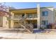 Exterior view of the condo building with stairs and landscaping at 2220 W Dora St # 215, Mesa, AZ 85201