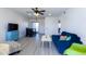 Bright living room with wood-look floors, comfy sofa, and dining area at 2220 W Dora St # 215, Mesa, AZ 85201