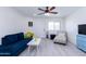 Living room with wood-look floors, a blue sofa, and a chaise lounge at 2220 W Dora St # 215, Mesa, AZ 85201