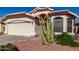 Single-story home with a two-car garage and desert landscaping at 2224 E Crest Ln, Phoenix, AZ 85024