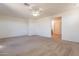 Spacious bedroom with neutral carpeting and ceiling fan at 23028 N 178Th Ln, Surprise, AZ 85387