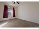 Well-lit bedroom with neutral carpeting and window curtains at 23028 N 178Th Ln, Surprise, AZ 85387