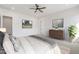 Comfortable bedroom with plush bedding, dresser, and ceiling fan at 27016 N 153Rd Dr, Surprise, AZ 85387