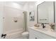Modern bathroom with white tile, bathtub, and updated vanity at 27017 N 153Rd Dr, Surprise, AZ 85387