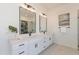 Modern bathroom with double sinks, quartz countertops, and large mirrors at 27017 N 153Rd Dr, Surprise, AZ 85387