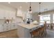 Open concept kitchen with island, white cabinetry, and breakfast nook at 27017 N 153Rd Dr, Surprise, AZ 85387