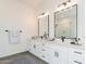 Modern bathroom with double vanity and large mirror at 27035 N 153Rd Dr, Surprise, AZ 85387