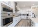 Modern white kitchen with stainless steel appliances and an island at 27035 N 153Rd Dr, Surprise, AZ 85387