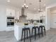 Modern kitchen with white cabinets, an island, and a gray tile backsplash at 27035 N 153Rd Dr, Surprise, AZ 85387
