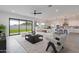 Living room with sliding doors leading to backyard, and view to kitchen at 27035 N 153Rd Dr, Surprise, AZ 85387