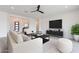 Living room featuring neutral colors, comfy furniture and a large TV at 27035 N 153Rd Dr, Surprise, AZ 85387