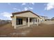 Exterior view of a home featuring covered patio, a concrete slab, and a dirt backyard at 2937 E Lawndale Ct, Gilbert, AZ 85298