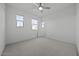 Bright bedroom featuring carpet flooring, white walls, and a ceiling fan at 2937 E Lawndale Ct, Gilbert, AZ 85298